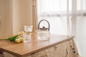 a table with a bag and flowers on it at Direct to Shinjuku Two bedrooms Higashi-Nakano Station Free luggage storage in Wada +32 photos