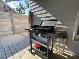 a bbq grill sitting on top of a patio at Maison familiale avec terrasse et proche plage à Saint-Brevin-les-Pins - FR-1-364-98 in Saint-Brevin-les-Pins