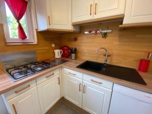 a kitchen with a sink and a stove at Maison familiale avec terrasse et proche plage à Saint-Brevin-les-Pins - FR-1-364-98 in Saint-Brevin-les-Pins +9 photos
