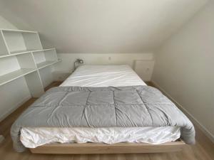 a large bed in a small room with white walls at Maison familiale avec terrasse et proche plage à Saint-Brevin-les-Pins - FR-1-364-98 in Saint-Brevin-les-Pins