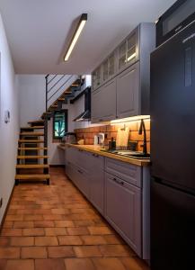 a kitchen with stainless steel appliances and a staircase at Zollhaus nad Zalewem Mietkowskim in Domanice