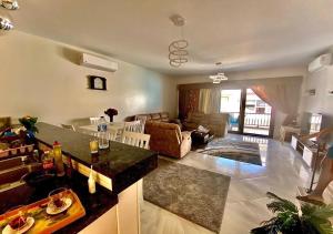 a living room with a couch and a table at بنتهاوس فاخر بإطلالة in El Alamein