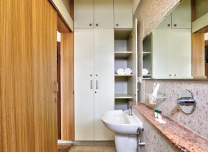 a bathroom with a white sink and a toilet at Acasa Suites - ITPL Whitefield, Near Manipal Hospital in Bengaluru +20 photos