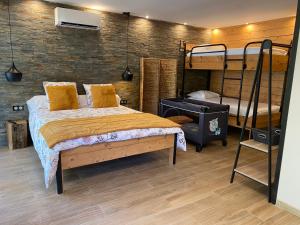 a bedroom with a bed and two bunk beds at Gîte des oursons - Climatisé in Guyans-Durnes