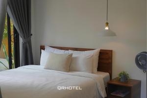 Voodi või voodid majutusasutuse QR Hotel Dalat toas