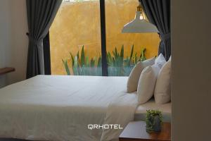 Voodi või voodid majutusasutuse QR Hotel Dalat toas