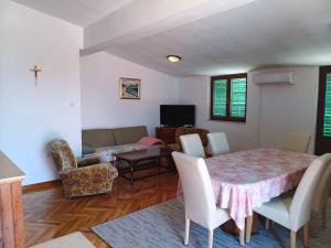 a living room with a table and chairs and a couch at Blažo in Neviđane