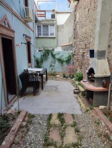 an alley with a table and benches in a building at Altun Konak in Ayvalık +4 photos