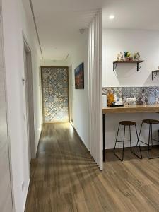 a hallway with a table and chairs in a house at Flower rooms Palermo in Palermo +36 photos