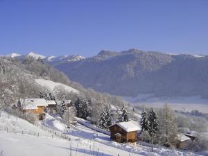 a snow covered cabin on a snowy hill with mountains at Appartement chalet rénové 6 pers avec terrasse proche Evian, ski et randonnée - FR-1-498-29 in Saint-Paul-en-Chablais +4 photos