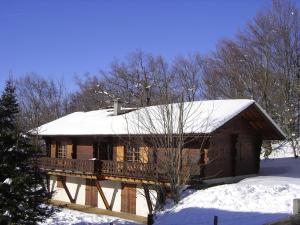 a log cabin with a snow covered roof at Appartement chalet rénové 6 pers avec terrasse proche Evian, ski et randonnée - FR-1-498-29 in Saint-Paul-en-Chablais