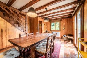 a dining room with a wooden table and chairs at Chalet Chez Juju in Abondance