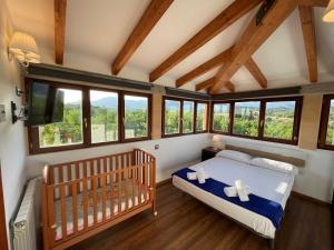 a bedroom with a crib in a room with windows at Casa Moragues in Santa Maria del Camí +41 photos