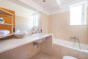 a bathroom with a sink and a bath tub at Einalia Holiday Homes near the Beach in (( Elaiónas )) +10 photos