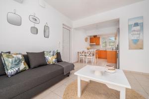 a living room with a couch and a table at Einalia Holiday Homes near the Beach in (( Elaiónas ))