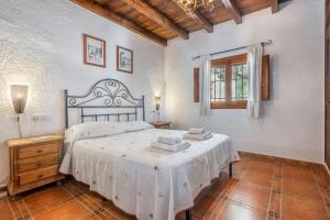 a bedroom with a large bed and a window at Finca El Gales Cortijo Los Olivos in Órgiva +21 photos