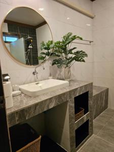 a bathroom with a sink and a mirror at Bang Po Hut in Ban Bang Po