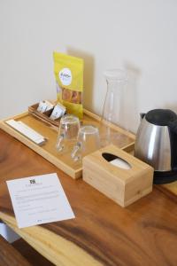 a wooden table with a cutting board and a tea kettle at Frania Boutique Hotel in San Juan
