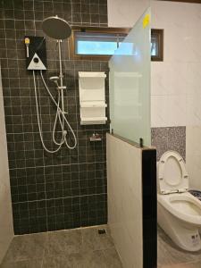 a bathroom with a shower and a toilet at Bang Po Hut in Ban Bang Po