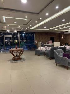a lobby with couches and a table in the middle at Jewel Inn El Bakry Hotel in Cairo