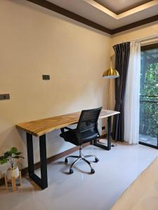 an office with a wooden desk and a chair at Bang Po Hut in Ban Bang Po