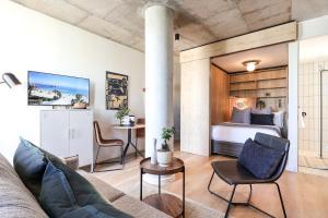 a bedroom with a bed and a table and chairs at THREE43 ON B - Fluent Serviced Apartments in Cape Town