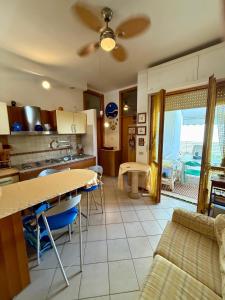 a kitchen and living room with a table and chairs at Casa di Anna in Senigallia