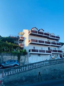 a building with a car parked in front of it at Apartman Igalo Stana in Igalo