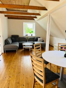 a living room with a couch and a table at Schou Lykke Syd in Tarm