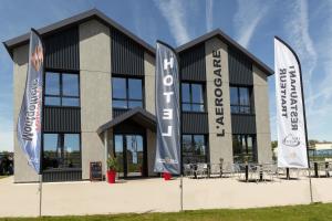 a building with flags in front of it at L'AEROGARE Amboise in Amboise