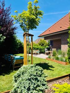 un giardino con altalena e albero di Haus Rose a Ribnitz-Damgarten