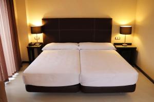 Cama o camas de una habitación en Hotel Real Balneario Carlos III