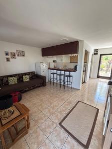 a living room with a couch and a kitchen at Villa Alexa Cesarica in Cesarica