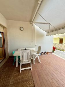 a dining room with a table and chairs on a patio at Casa di Anna in Senigallia +10 photos