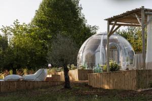 a greenhouse and a glass dome in a garden at Bulle de Leygonie in Saint-Aulaire