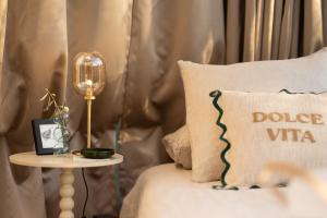 a bed with a pillow and a table with a side table at Bulle de Leygonie in Saint-Aulaire