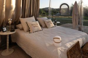 a bedroom with a bed with pillows and a window at Bulle de Leygonie in Saint-Aulaire