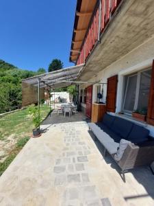 a patio with a blue couch and a table at casa Donadiolla in Maiola