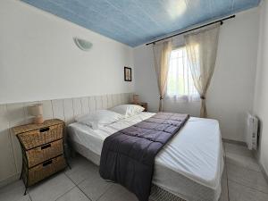 ein kleines Schlafzimmer mit einem Bett und einem Fenster in der Unterkunft Maisonnette lumineuse proche plage avec piscine - FR-1-476-198 in La Faute-sur-Mer