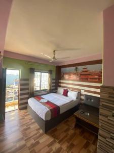 a bedroom with a large bed and a window at Hotel Visit Pokhra in Pokhara