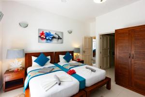 Postel nebo postele na pokoji v ubytování Casa Tara Villas