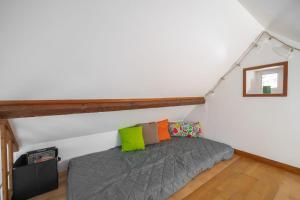 a bedroom with a bed in a attic at La Cabana - Parking - Jardin in Rubercy