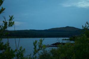 a view of a lake with mountains in the background at Auchenhill Lodge in Denny