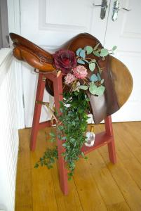 a purse sitting on a chair with a plant at Auchenhill Lodge in Denny