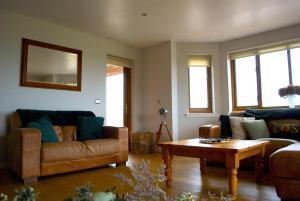 a living room with two couches and a coffee table at Auchenhill Lodge in Denny