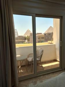 a view of a balcony with a table and chairs at Enter Pyramids Inn in Cairo