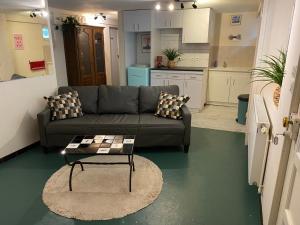 a living room with a couch and a table at Grande Maison en Bord de l'Eau avec Jardin - 6 Chambres, Proche Commerces - FR-1-410-442 in La Chartre-sur-le-Loir