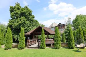 a pavilion in the garden of a house at Cazare la Munte cu Piscină in Bistra
