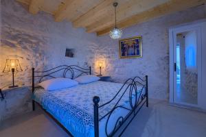 a bedroom with a bed with a blue comforter at Villa Biankura in Blato