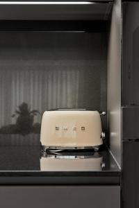 a toaster sitting on top of a kitchen counter at The Como City Golden Loft by Aura Luxury Collection in Como +11 photos